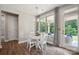 Cozy breakfast nook features natural light, wood floors, and access to outdoor space at 10437 Paper Birch Dr, Charlotte, NC 28215