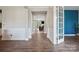 Hallway view with hardwood flooring and doorway views to an office and living room at 10437 Paper Birch Dr, Charlotte, NC 28215