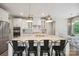 Bright kitchen featuring a granite island with barstool seating and modern pendant lighting at 10437 Paper Birch Dr, Charlotte, NC 28215