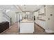 Bright open kitchen with island, stainless appliances, and plenty of counter space for cooking at 10437 Paper Birch Dr, Charlotte, NC 28215