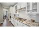 Bright kitchen with stainless steel appliances, granite counters and white cabinetry at 10437 Paper Birch Dr, Charlotte, NC 28215