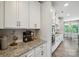 Modern kitchen with stainless appliances, granite counters, subway tile backsplash, and ample cabinetry at 10437 Paper Birch Dr, Charlotte, NC 28215