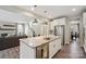 Kitchen island featuring granite countertop, stainless steel sink, and modern pendant lighting at 10437 Paper Birch Dr, Charlotte, NC 28215