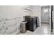 Modern laundry room featuring a sleek washer and dryer set, laundry rack, and ample storage space at 10437 Paper Birch Dr, Charlotte, NC 28215
