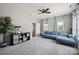 Spacious living room with a blue sectional, decorative curtains, and ample space for entertainment and relaxation at 10437 Paper Birch Dr, Charlotte, NC 28215