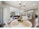 Open floor plan connecting breakfast nook, kitchen and living room with staircase in background at 10437 Paper Birch Dr, Charlotte, NC 28215