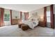 Large bedroom with carpet, windows with curtains and bedroom furniture at 10437 Paper Birch Dr, Charlotte, NC 28215