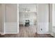 Bright office space with a ceiling fan, a white desk, and hardwood floors at 10437 Paper Birch Dr, Charlotte, NC 28215