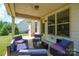 Inviting covered patio with comfortable outdoor seating, ideal for relaxing and entertaining in a private setting at 10437 Paper Birch Dr, Charlotte, NC 28215