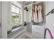 Well-organized walk-in closet with built-in shelving, hanging racks, and natural light from the window at 10437 Paper Birch Dr, Charlotte, NC 28215