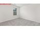 Bright bedroom with large window, plush neutral carpet, and white walls at 11136 Cardinal Creek Ave, Charlotte, NC 28215