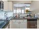 Functional kitchen with stainless steel appliances, white cabinets, and a view into the dining area at 11521 Savannah Creek Dr, Charlotte, NC 28273