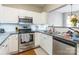 Modern kitchen featuring stainless steel appliances, white cabinets, and a stylish backsplash at 11521 Savannah Creek Dr, Charlotte, NC 28273