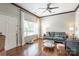 Inviting living room with hardwood floors, a modern ceiling fan and large window providing ample natural light at 11521 Savannah Creek Dr, Charlotte, NC 28273