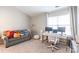 Home office featuring a desk with multiple monitors, a cozy couch, and abundant natural light at 11521 Savannah Creek Dr, Charlotte, NC 28273