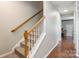 Bright staircase with carpeted steps, white risers, and a wood railing leading to the upper level at 11521 Savannah Creek Dr, Charlotte, NC 28273