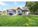A well-maintained backyard with green lawn, patio set, and charming hydrangea bushes at 117 Franklin St, Clover, SC 29710