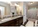 Bathroom boasts double vanity with granite counters, dark cabinets, and a tiled shower at 117 Franklin St, Clover, SC 29710