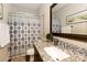 Bathroom featuring a granite countertop vanity, framed mirror, and decorative shower curtain at 117 Franklin St, Clover, SC 29710