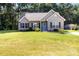 Charming single-story home featuring a well-manicured lawn and a welcoming blue front door at 117 Franklin St, Clover, SC 29710