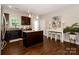 Modern kitchen featuring a central island, granite countertops, and dark wood cabinetry at 117 Franklin St, Clover, SC 29710