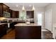 Modern kitchen features dark wood cabinets, granite counters, an island, and stainless steel appliances at 117 Franklin St, Clover, SC 29710