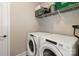 Laundry room with white washer and dryer units with a shelf for storage at 117 Franklin St, Clover, SC 29710
