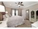 Spacious main bedroom with a large decorative headboard, ceiling fan and ensuite bathroom at 117 Franklin St, Clover, SC 29710