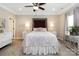 A lovely main bedroom with a decorative headboard, ceiling fan and neutral decor at 117 Franklin St, Clover, SC 29710