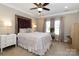 A serene main bedroom is decorated in neutral colors, with a ceiling fan and natural light from the window at 117 Franklin St, Clover, SC 29710