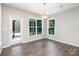 Bright dining area featuring hardwood floors, natural light, and access to outdoor space at 12140 Mcdowell Pl, Huntersville, NC 28078
