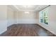 An elegant dining room featuring hardwood floors, wainscoting, and a chandelier at 12140 Mcdowell Pl, Huntersville, NC 28078