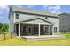 Exterior view of a two-story home with a screened in porch and black fencing at 12140 Mcdowell Pl, Huntersville, NC 28078