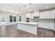 Stylish kitchen with island, stainless appliances and eat in space next to sun-filled windows at 12140 Mcdowell Pl, Huntersville, NC 28078