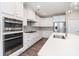 Well-equipped kitchen with white cabinets, stainless steel appliances, and sleek countertops at 12140 Mcdowell Pl, Huntersville, NC 28078
