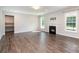 Inviting living room featuring a fireplace, hardwood floors, and large windows at 12140 Mcdowell Pl, Huntersville, NC 28078