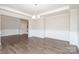 A spacious, open living room showcases hardwood floors, recessed lighting, and elegant wainscoting at 12140 Mcdowell Pl, Huntersville, NC 28078