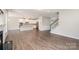 Living room with fireplace flowing seamlessly into a modern kitchen with white cabinets at 12140 Mcdowell Pl, Huntersville, NC 28078