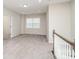 Cozy upstairs loft area featuring neutral decor, and ample space for relaxation at 12140 Mcdowell Pl, Huntersville, NC 28078