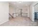 Bright upstairs loft area featuring neutral decor, and staircase with a stained wood railing at 12140 Mcdowell Pl, Huntersville, NC 28078