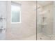 This spa-like shower features sleek tile, glass enclosure, and rainfall shower head at 12140 Mcdowell Pl, Huntersville, NC 28078