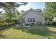 Spacious backyard featuring a patio with outdoor seating, lush lawn, and privacy fencing at 1304 Hammond Dr, Matthews, NC 28104