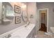 Bright bathroom showcasing dual sinks, decorative mirrors, and neutral decor at 1304 Hammond Dr, Matthews, NC 28104