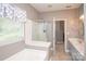Bright bathroom featuring tub and shower with dual sink vanity at 1304 Hammond Dr, Matthews, NC 28104