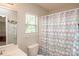 Neutral bathroom features a window, toilet, and tub with a stylish patterned shower curtain at 1304 Hammond Dr, Matthews, NC 28104