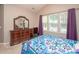 Comfortable bedroom with a large window, wooden furniture, and vaulted ceilings at 1304 Hammond Dr, Matthews, NC 28104