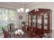 Elegant dining room with a dark wood table, china cabinet, and a window providing natural light at 1304 Hammond Dr, Matthews, NC 28104