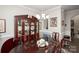 Well-lit dining room featuring a wooden table and an elegant china cabinet for ample storage at 1304 Hammond Dr, Matthews, NC 28104