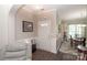 Welcoming foyer with elegant wainscoting, a cozy seating area, and hardwood floors at 1304 Hammond Dr, Matthews, NC 28104
