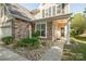 Inviting front porch with decorative stone accents, small garden, and cozy seating area at 1304 Hammond Dr, Matthews, NC 28104
